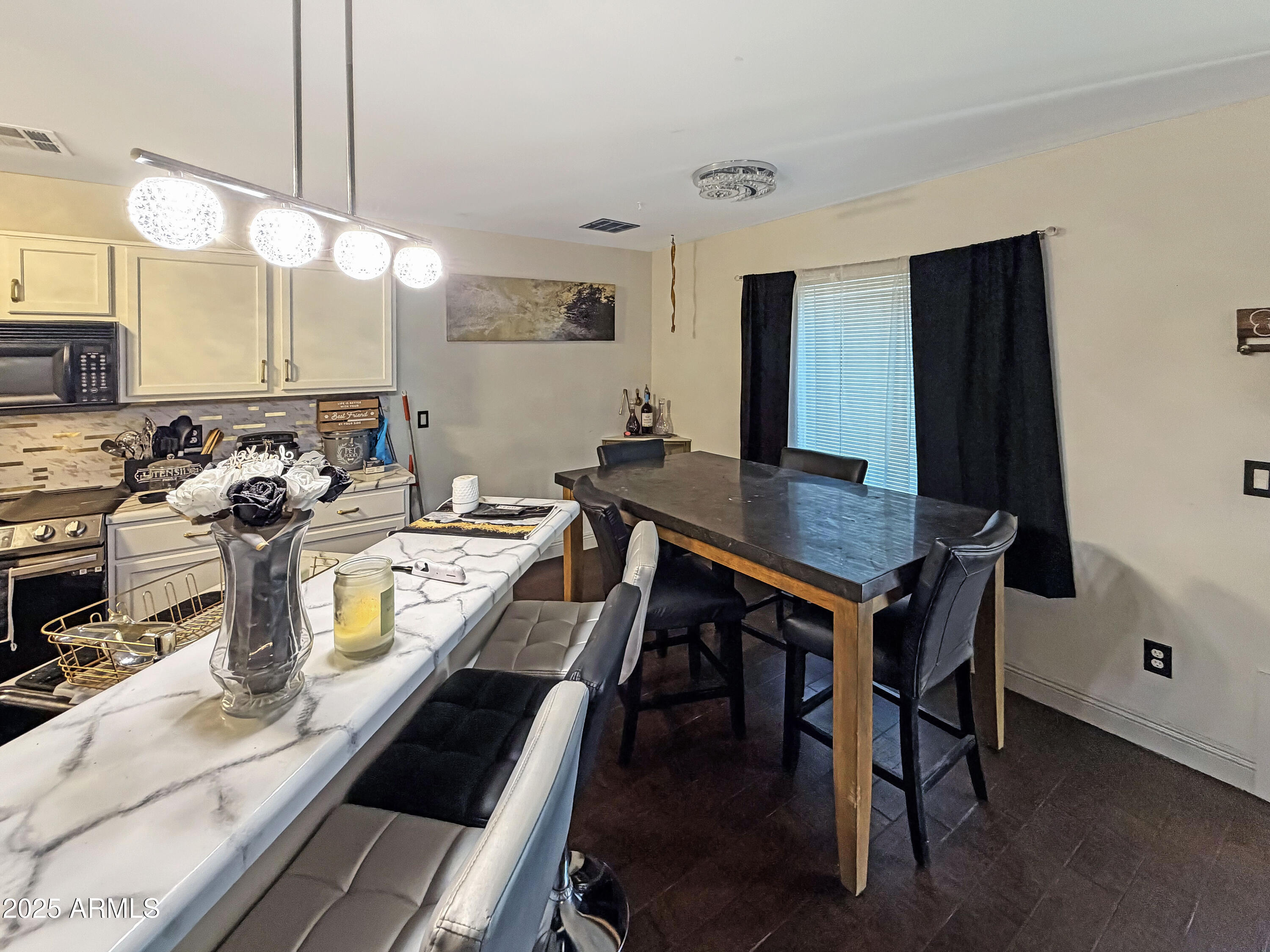 166 South 18 TH Street Coolidge, AZ 85128 - Photo 8 of 31 a room with a table chairs and wooden floor
