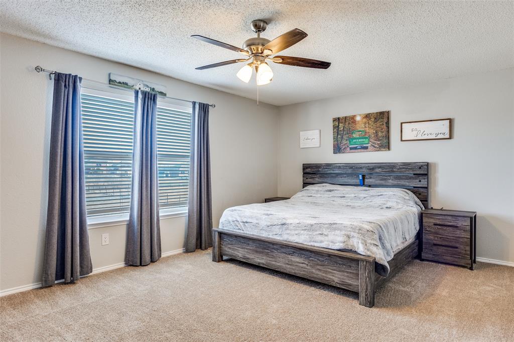 1026 County Road 544 Nevada, TX 75173 - Photo 19 of 32 a bedroom with a bed and a ceiling fan
