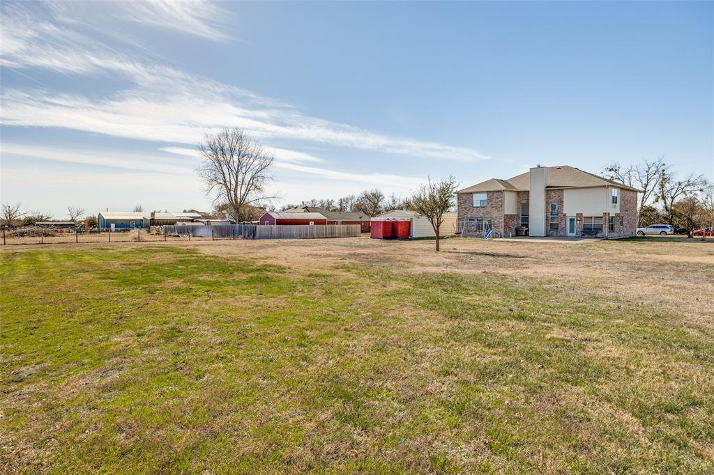 1026 County Road 544 Nevada, TX 75173 - Photo 27 of 32 a view of a large pool with lawn chairs under an umbrella