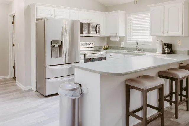 a kitchen with stainless steel appliances a refrigerator and a stove top oven