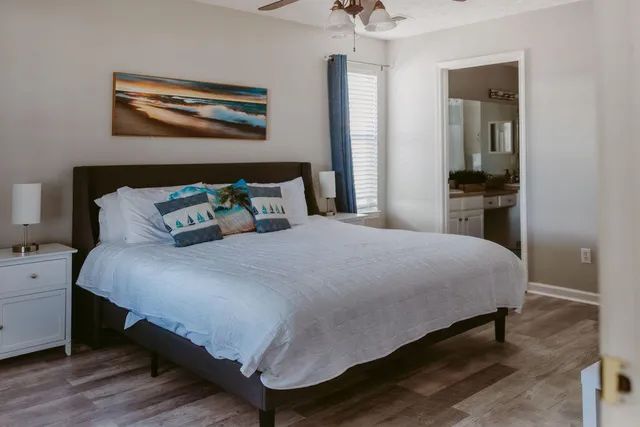 a bedroom with a bed and a painting on the wall