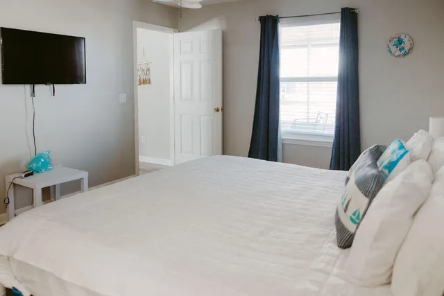 a bedroom with a bed and a flat screen tv