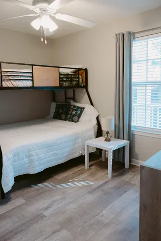 a bedroom with a bed and a chandelier
