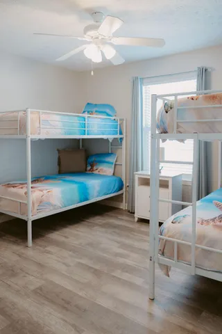 a bedroom with a bed and a ceiling fan