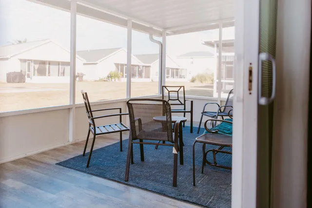 a dining room with furniture and wooden floor
