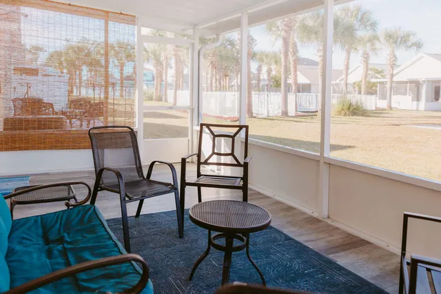 a balcony with chairs and a table