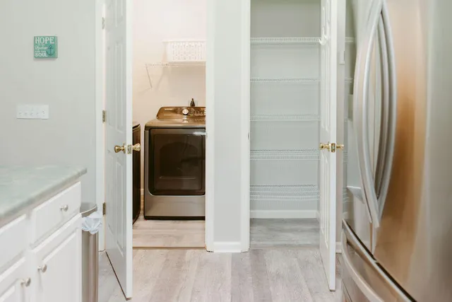 a bathroom with a walk in closet and mirror