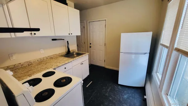 a kitchen with a refrigerator and a stove