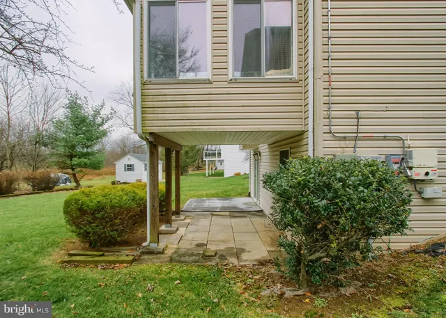a view of a house with a small yard and plants