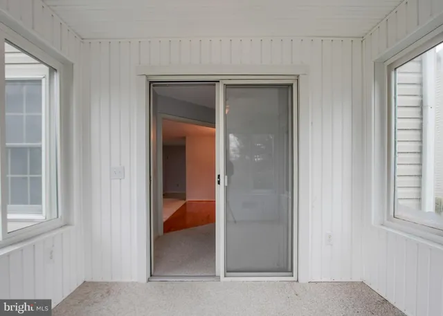 a view of a hallway with closet and bathroom