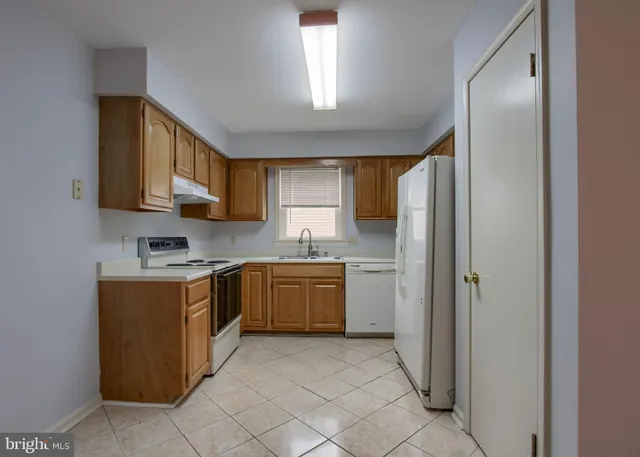 a kitchen with a stove top oven sink and cabinets