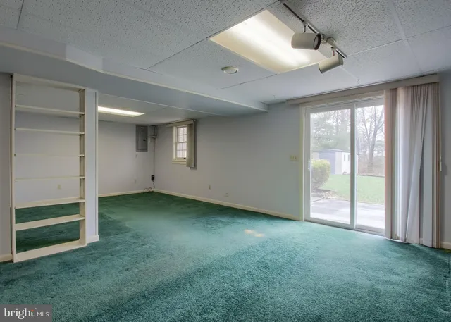 an empty room with closet and windows
