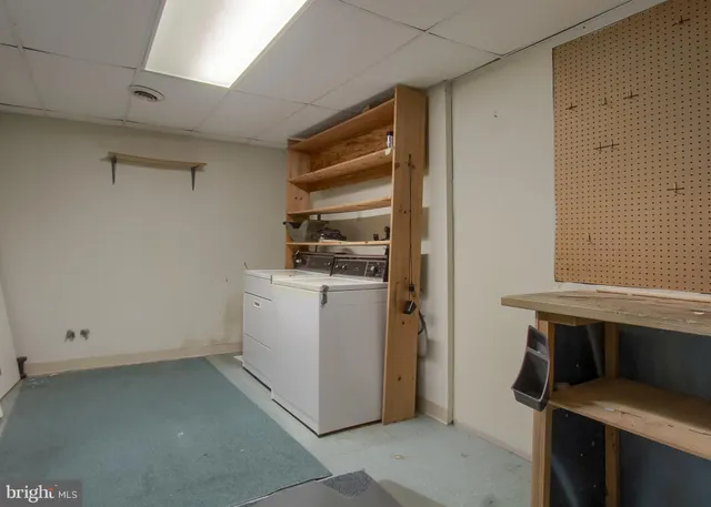 a view of storage and utility room with washer and dryer