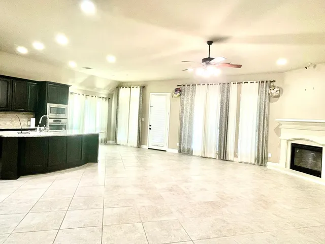 a view of a kitchen with a sink and a refrigerator
