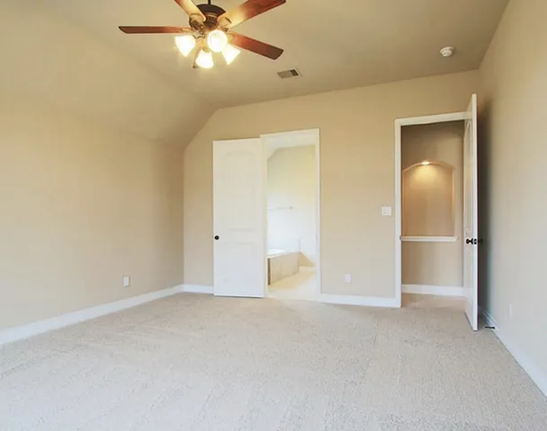 an empty room with closet and a chandelier fan