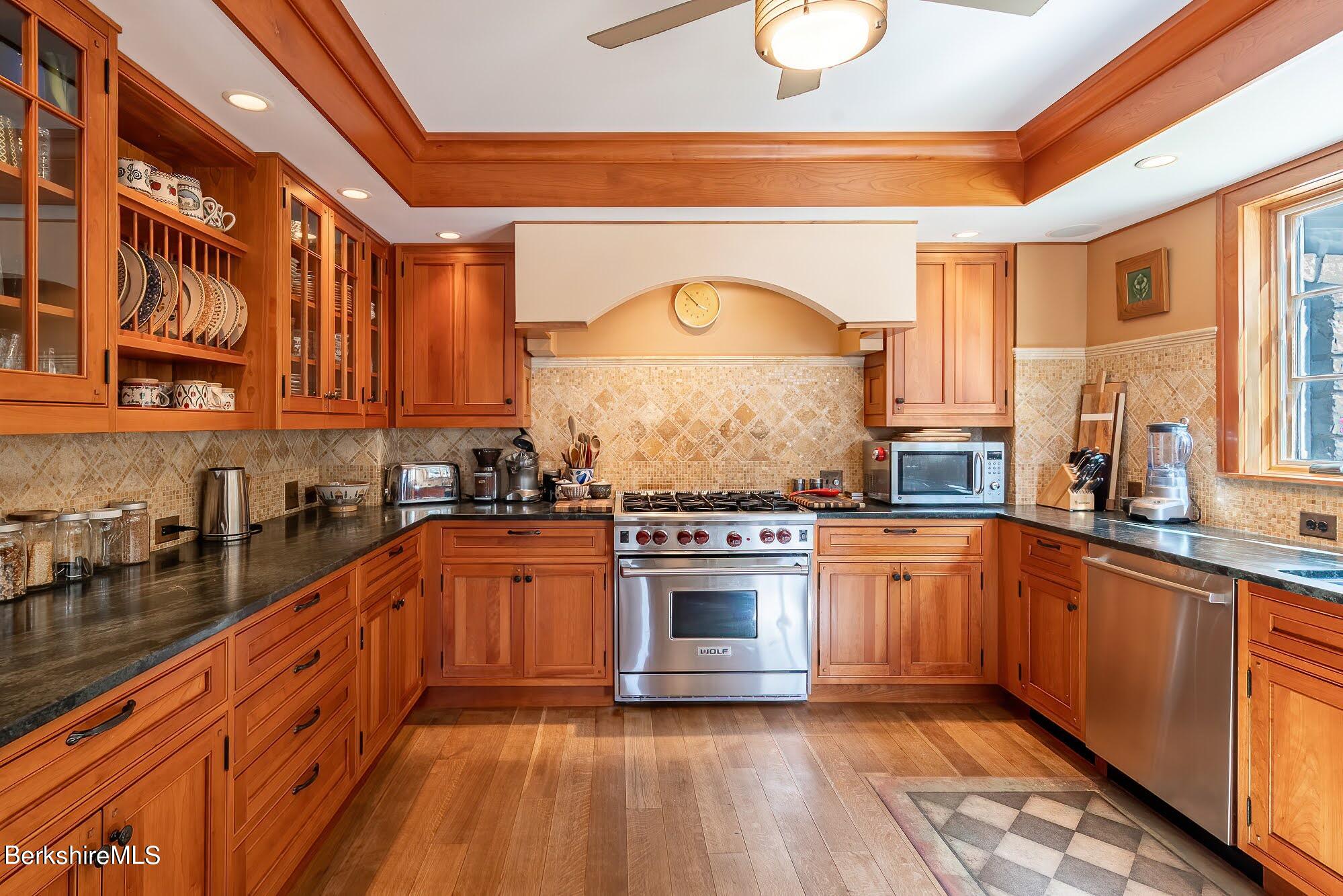 17 Cronk Road Monterey, MA 01245 - Photo 17 of 56 a large kitchen with stainless steel appliances granite countertop a stove and a sink