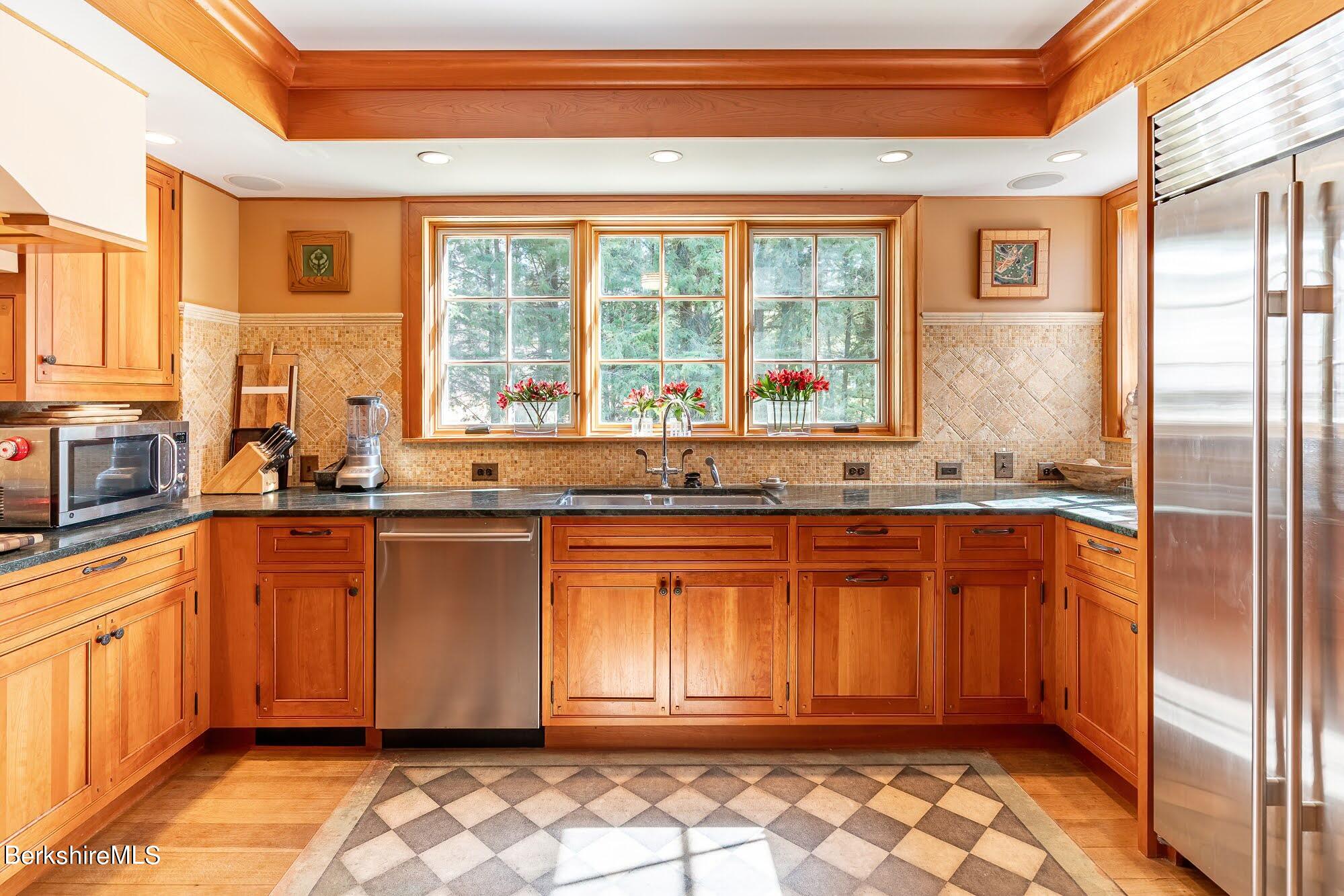 17 Cronk Road Monterey, MA 01245 - Photo 18 of 56 a large kitchen with stainless steel appliances granite countertop a refrigerator and a sink