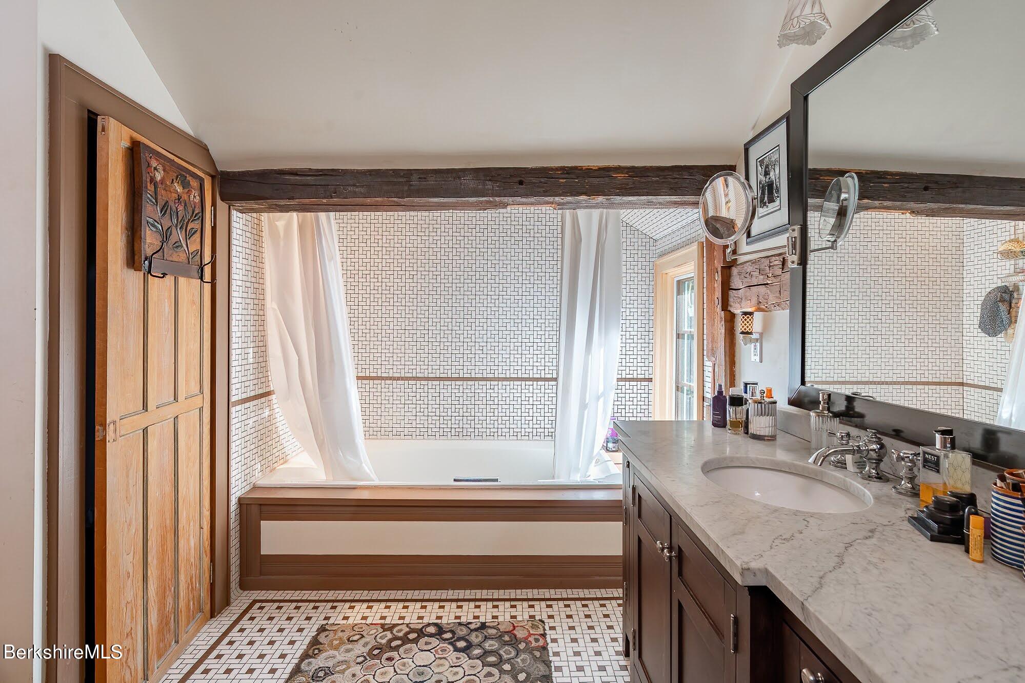 17 Cronk Road Monterey, MA 01245 - Photo 38 of 56 a bathroom with a granite countertop sink a mirror and a bathtub