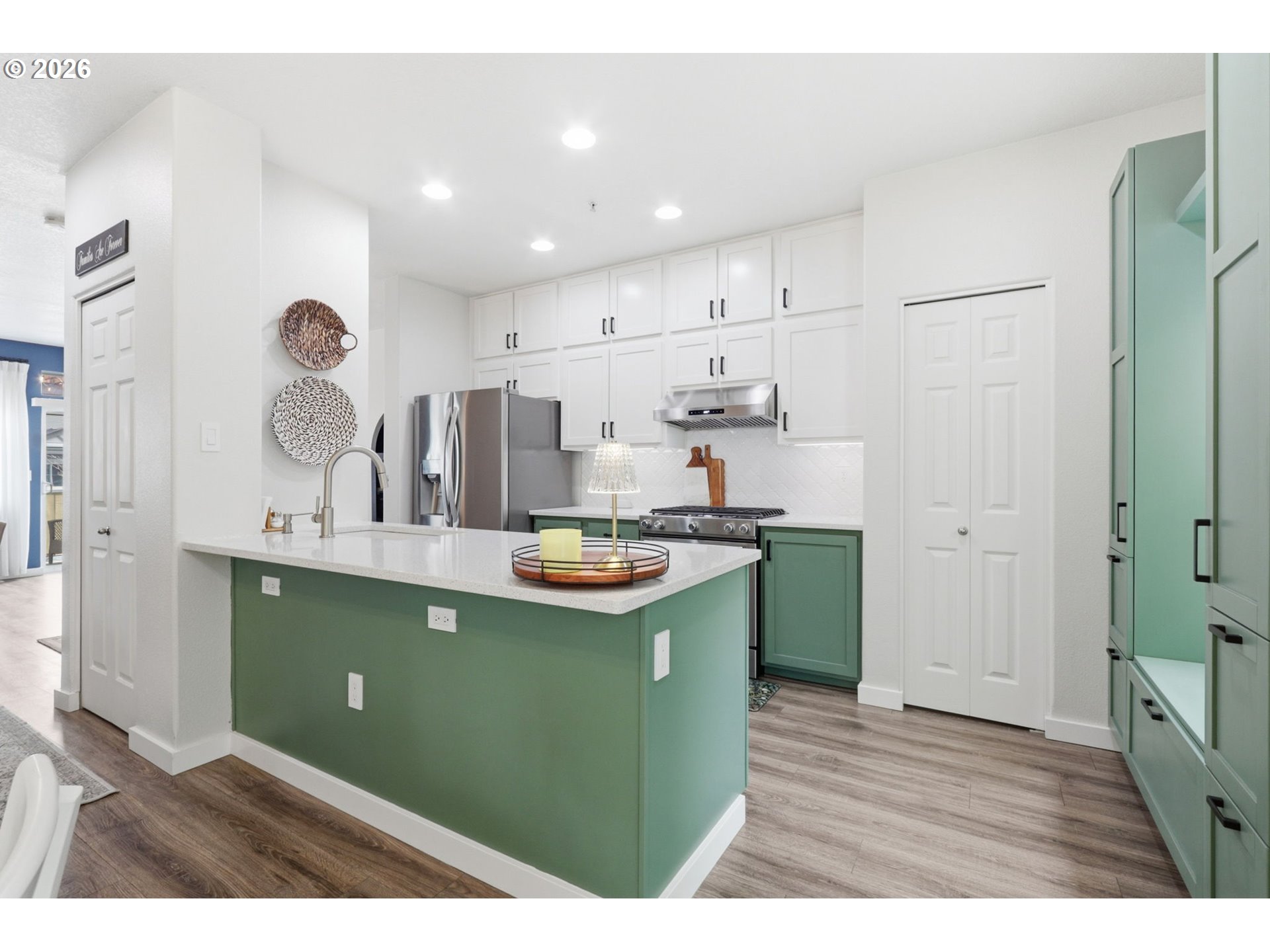 15095 Southwest Warbler Way, Unit 104 Beaverton, OR 97007 - Photo 13 of 46 a kitchen with cabinets and wooden floors