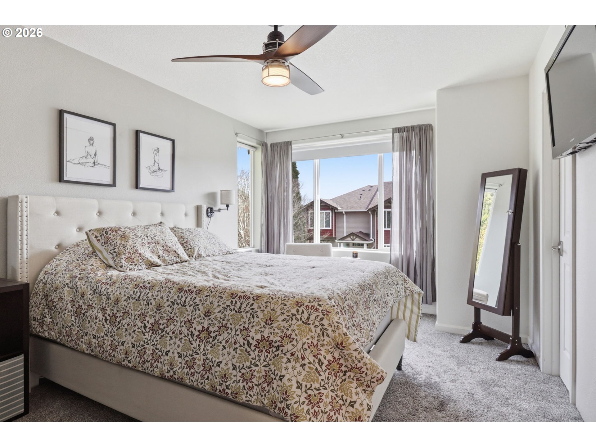 15095 Southwest Warbler Way, Unit 104 Beaverton, OR 97007 - Photo 18 of 46 a bed sitting in a spacious bedroom next to a window