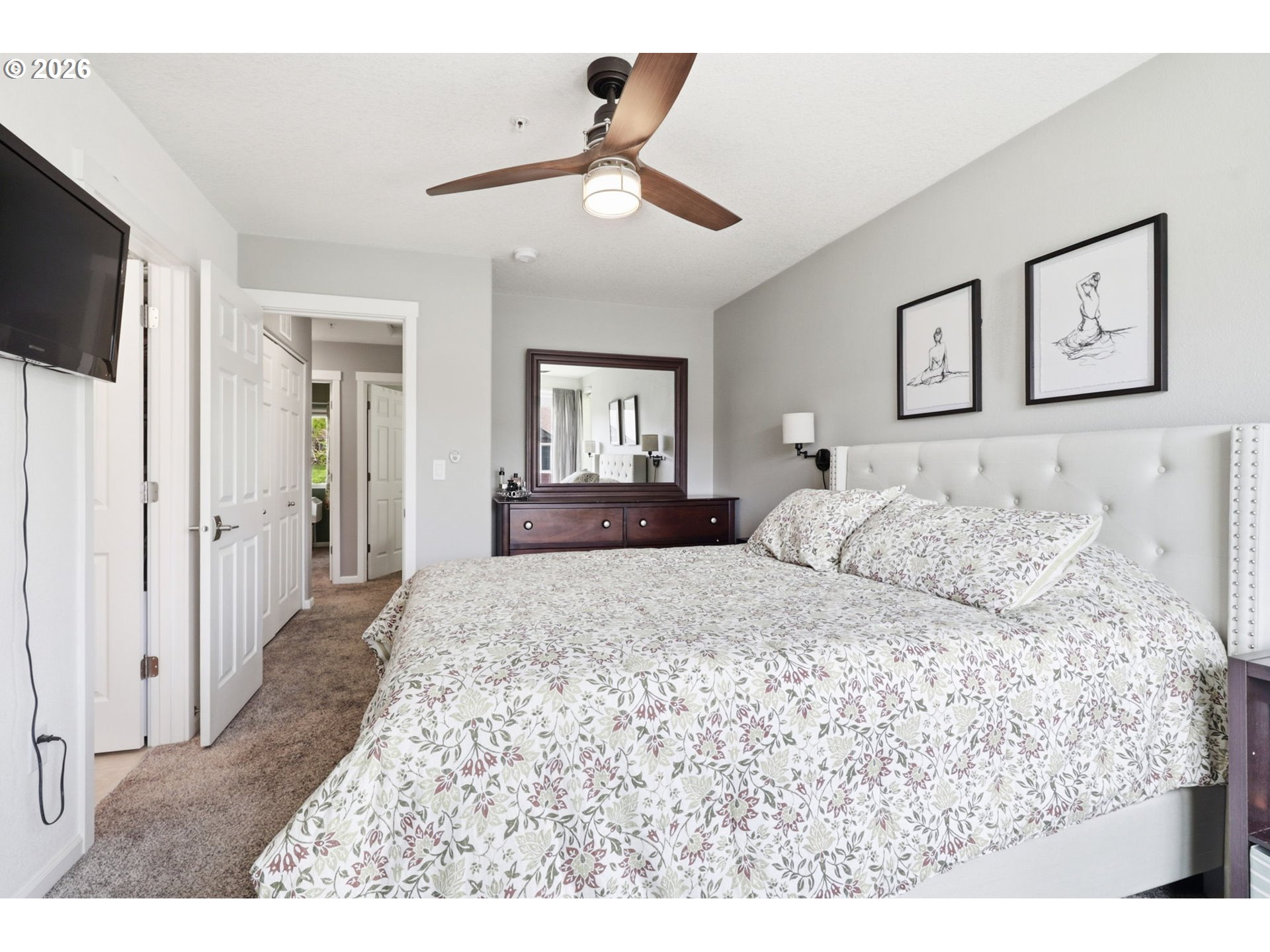 15095 Southwest Warbler Way, Unit 104 Beaverton, OR 97007 - Photo 20 of 46 a bedroom with a large bed and a flat screen tv