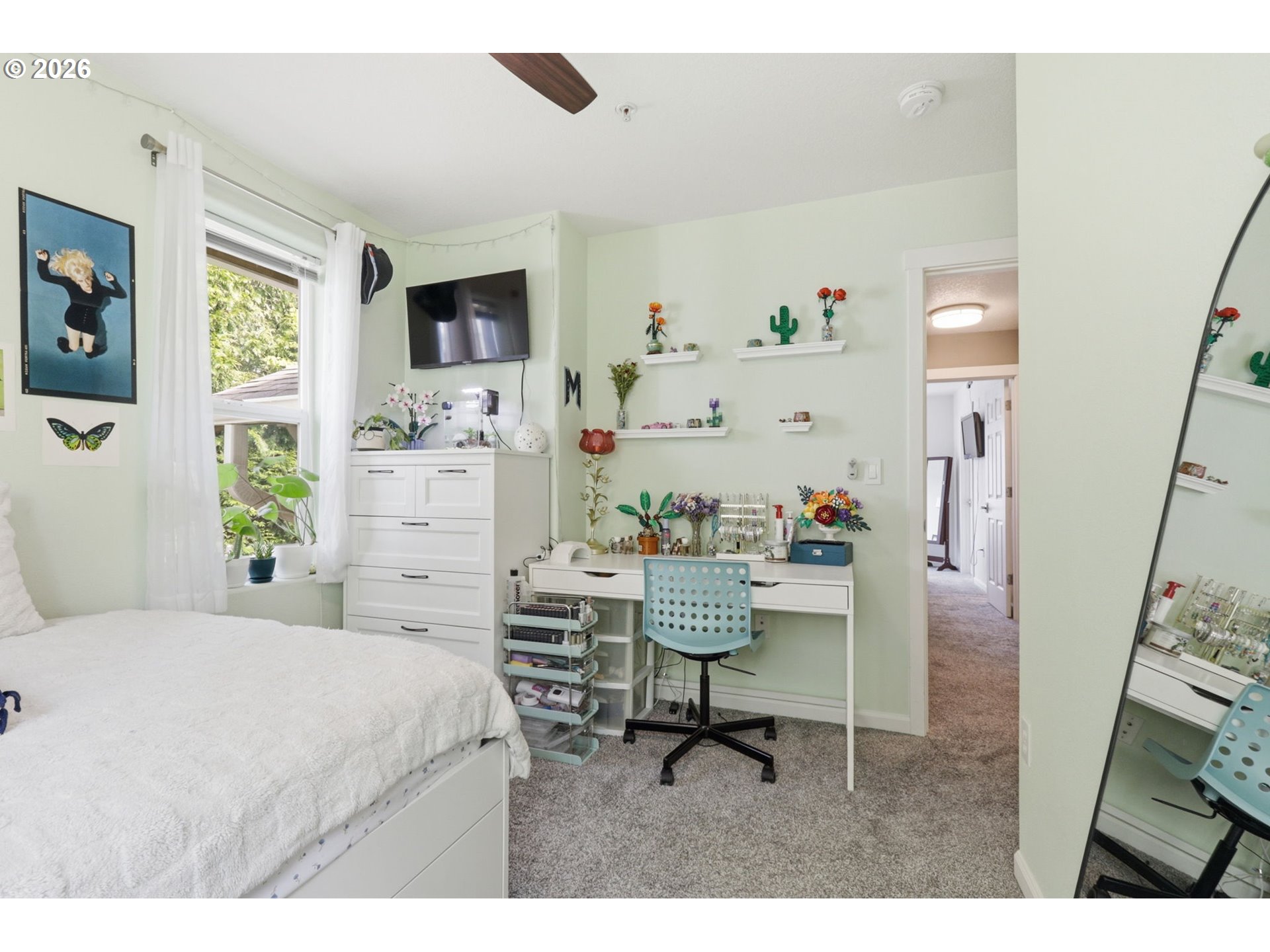 15095 Southwest Warbler Way, Unit 104 Beaverton, OR 97007 - Photo 24 of 46 a bedroom with a bed and a flat screen tv