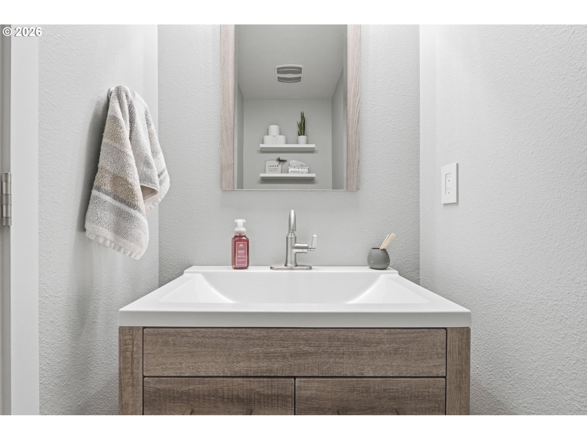 15095 Southwest Warbler Way, Unit 104 Beaverton, OR 97007 - Photo 30 of 46 a bathroom with a sink vanity and a mirror