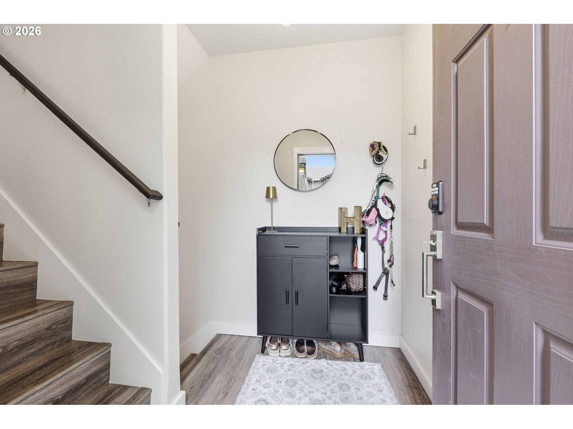 15095 Southwest Warbler Way, Unit 104 Beaverton, OR 97007 - Photo 3 of 46 a view of a hallway with washer and dryer