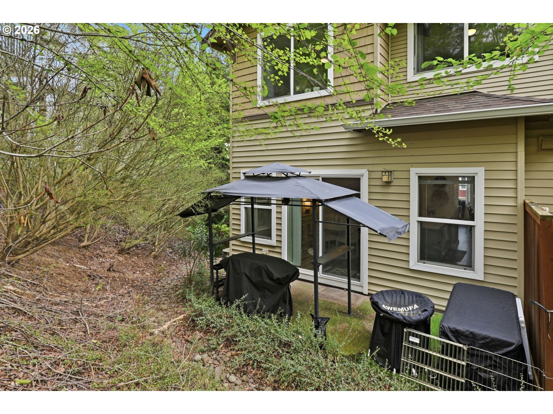 15095 Southwest Warbler Way, Unit 104 Beaverton, OR 97007 - Photo 36 of 46 a backyard of a house with table and chairs