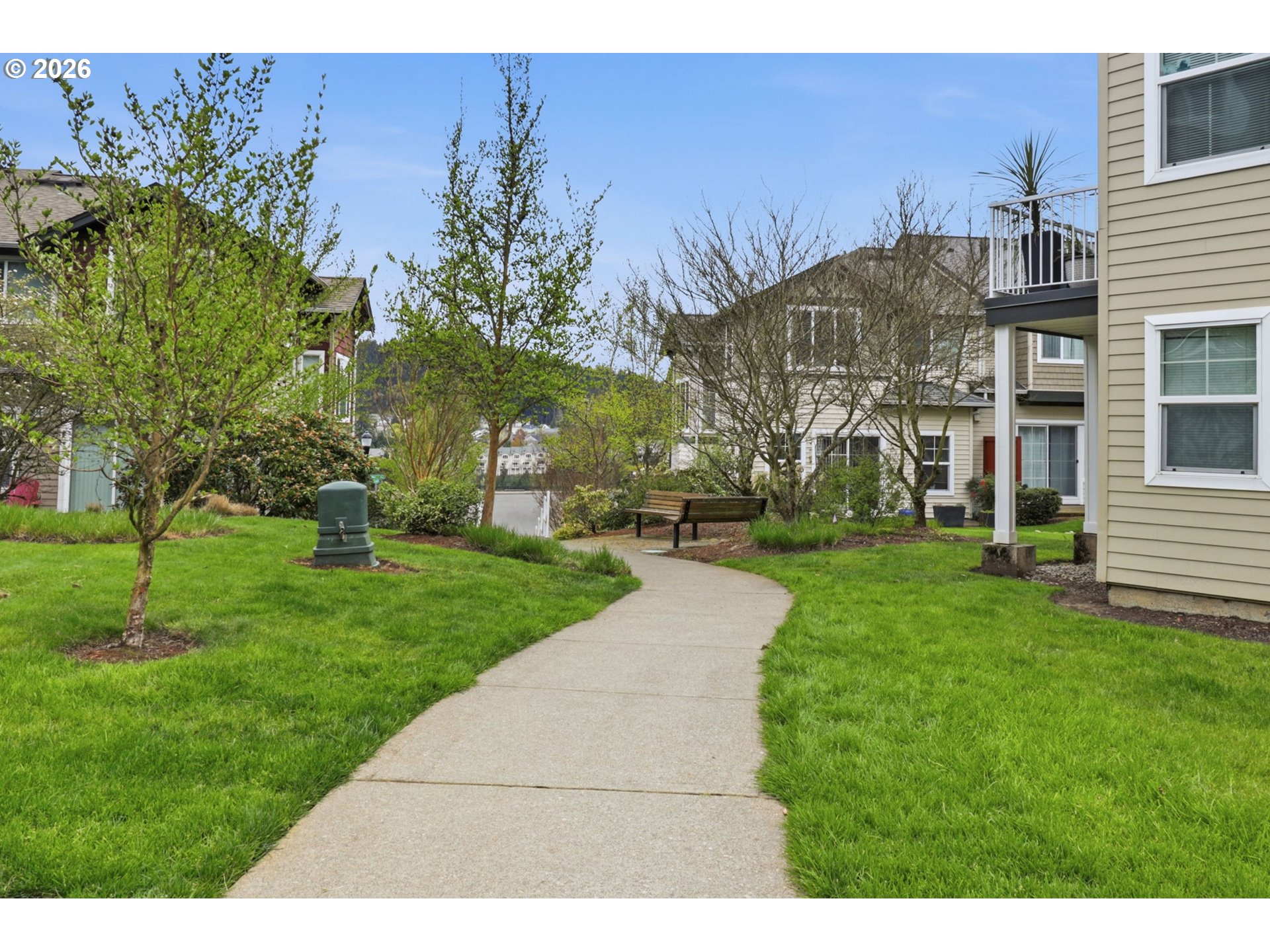 15095 Southwest Warbler Way, Unit 104 Beaverton, OR 97007 - Photo 37 of 46 a view of a building with a yard