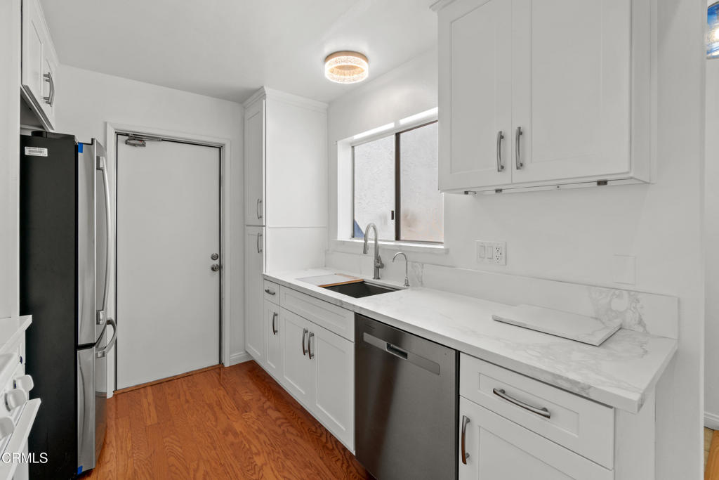426 Reed Way Port Hueneme, CA 93041 - Photo 13 of 34 a kitchen with a sink and cabinets