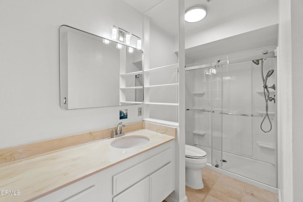 426 Reed Way Port Hueneme, CA 93041 - Photo 24 of 34 a bathroom with a shower sink vanity mirror and toilet