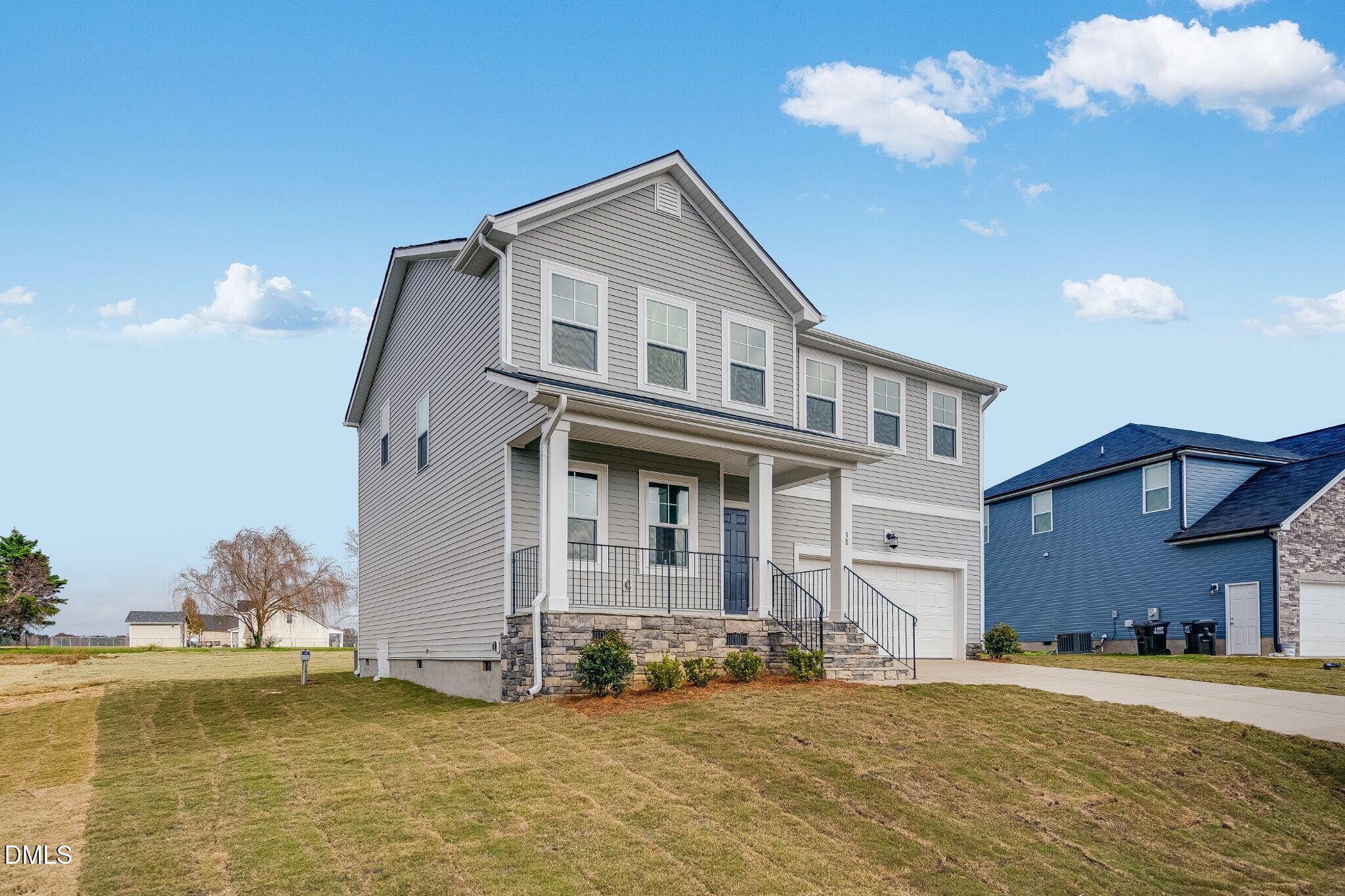 654 Roy Adams Road Angier, NC 27501 - Photo 4 of 38 a front view of a house with a yard