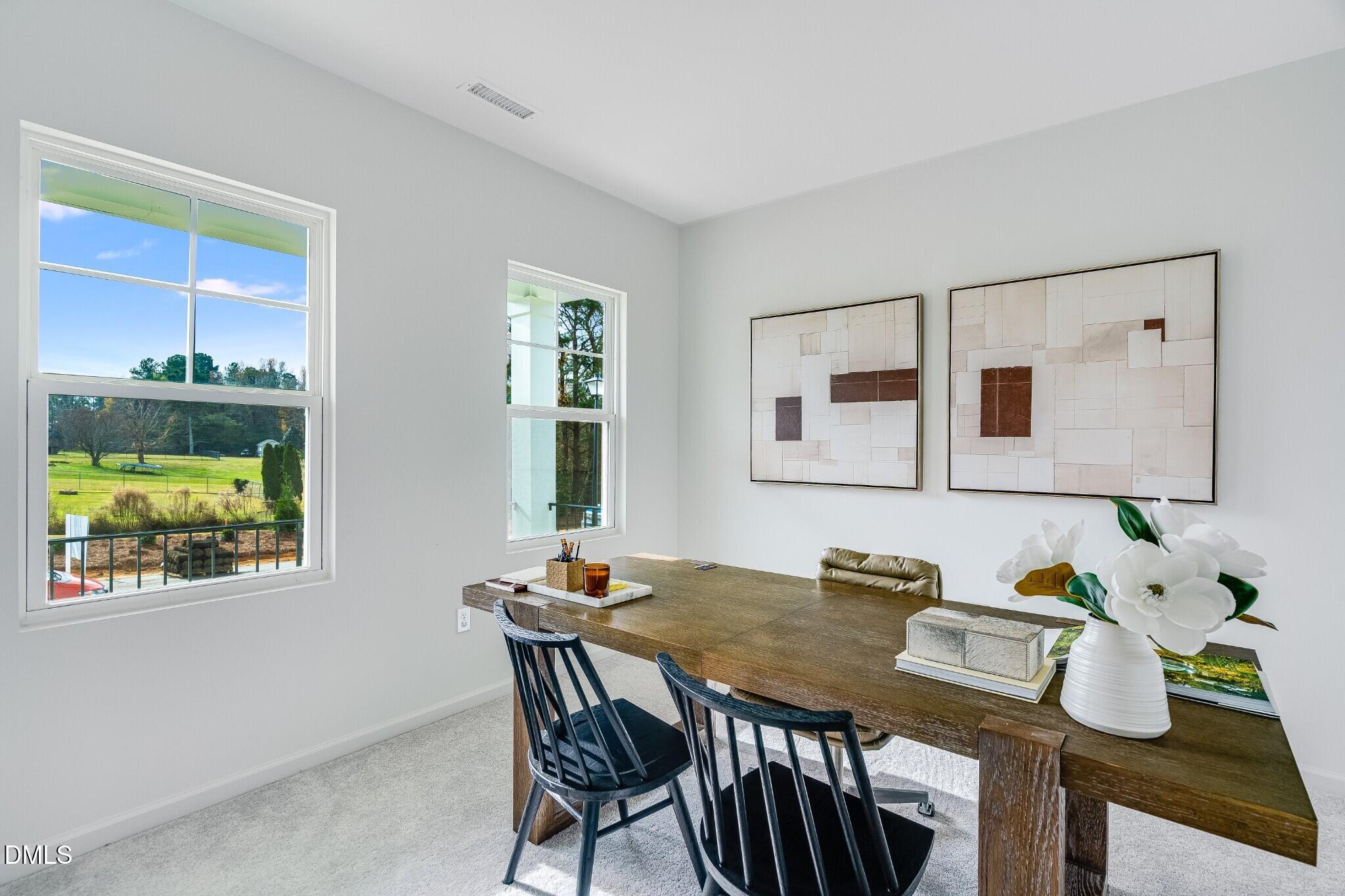 654 Roy Adams Road Angier, NC 27501 - Photo 6 of 38 a view of a dining room with furniture a potted plant and wooden floor