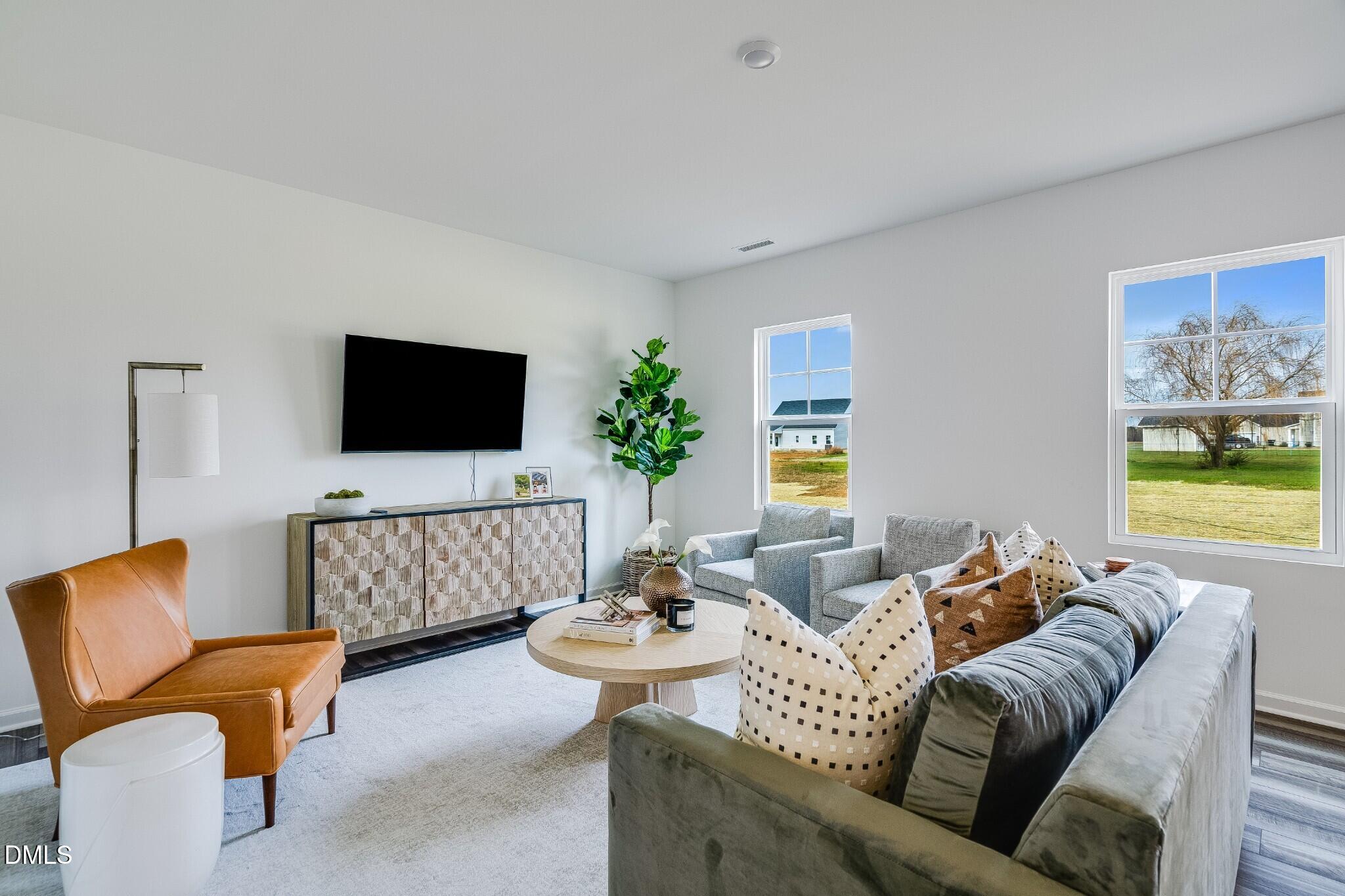 654 Roy Adams Road Angier, NC 27501 - Photo 8 of 38 a living room with furniture and a flat screen tv