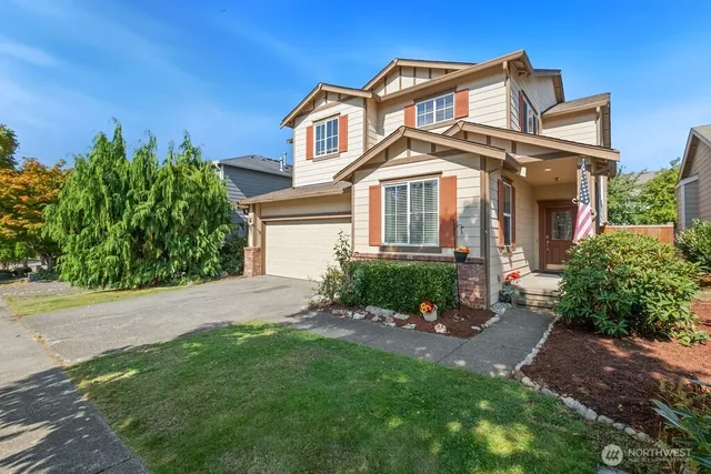 a front view of a house with a garden