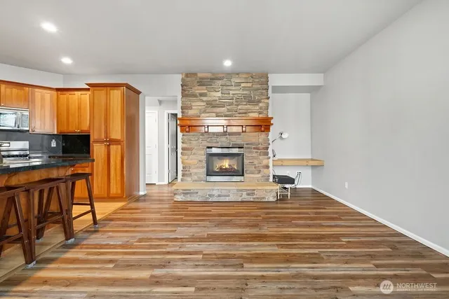 a view of a kitchen with a sink and a fireplace