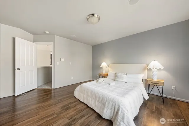 a bedroom with a bed and a lamp