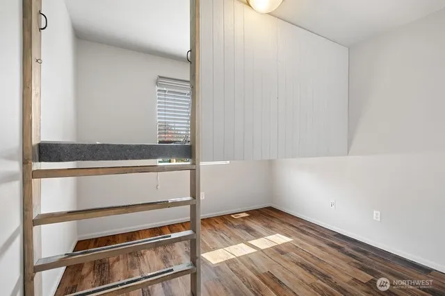 a view of walk in closet with wooden floor