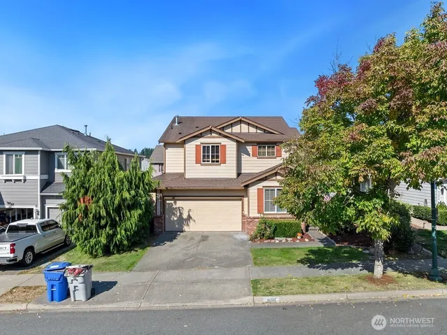 a front view of a house with a garden