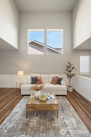 a living room with furniture wooden floor and a lamp