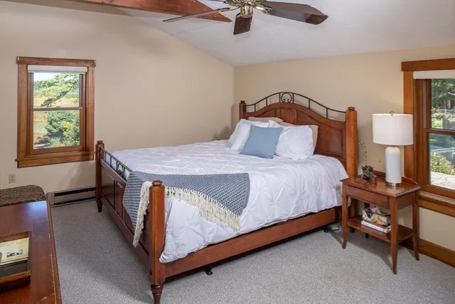 a bedroom with a bed chair and window