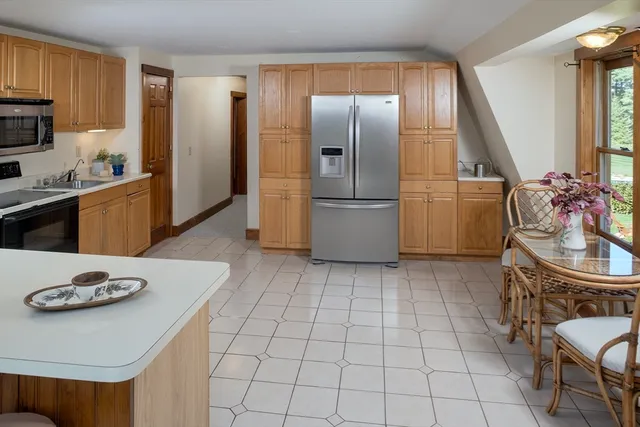 a kitchen with furniture a refrigerator and a sink