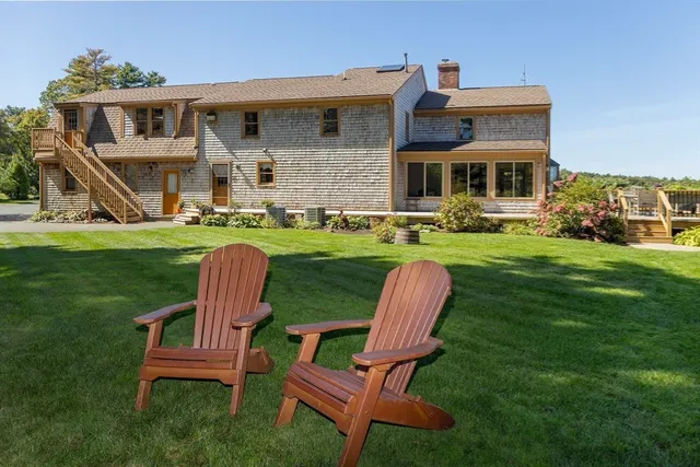 a front view of a house with a yard table and chairs