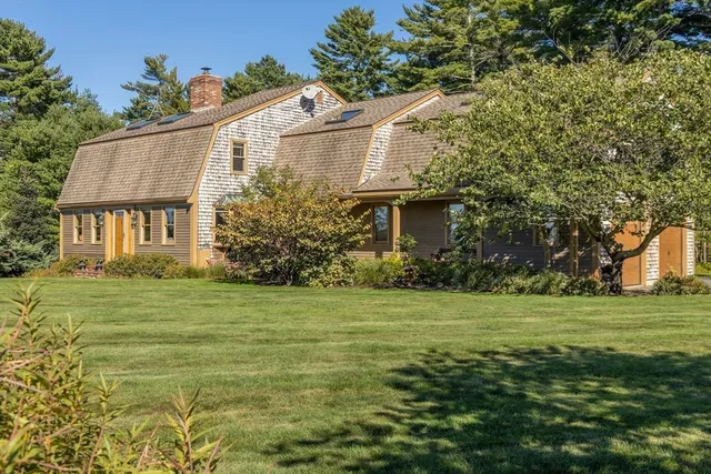 a front view of a house with a garden