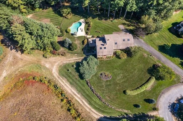 an aerial view of a residential houses with outdoor space