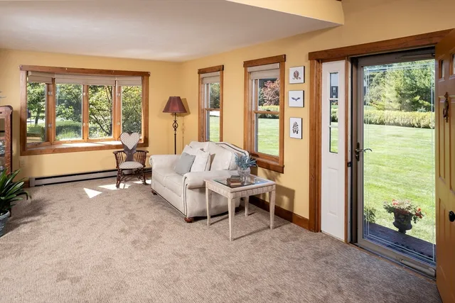a living room with furniture and large windows