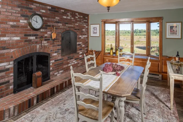 a dining room with furniture and a fireplace