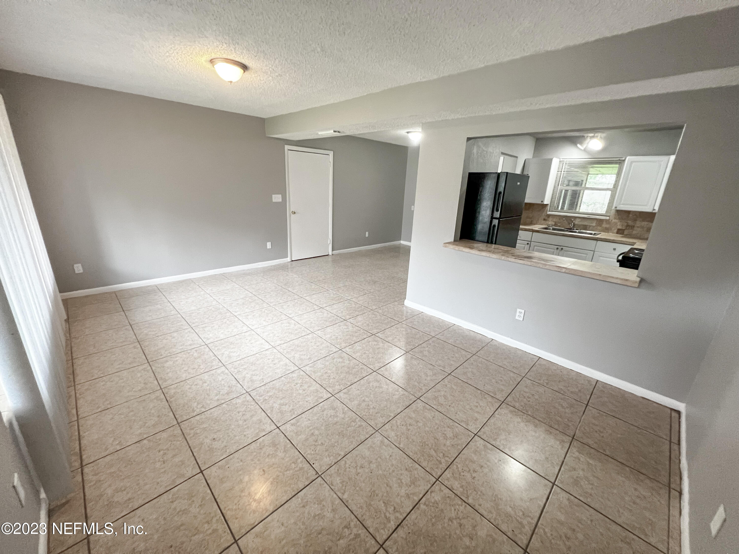 7025 Rollo Road Jacksonville, FL 32205 - Photo 5 of 37 a view of an empty room and a window