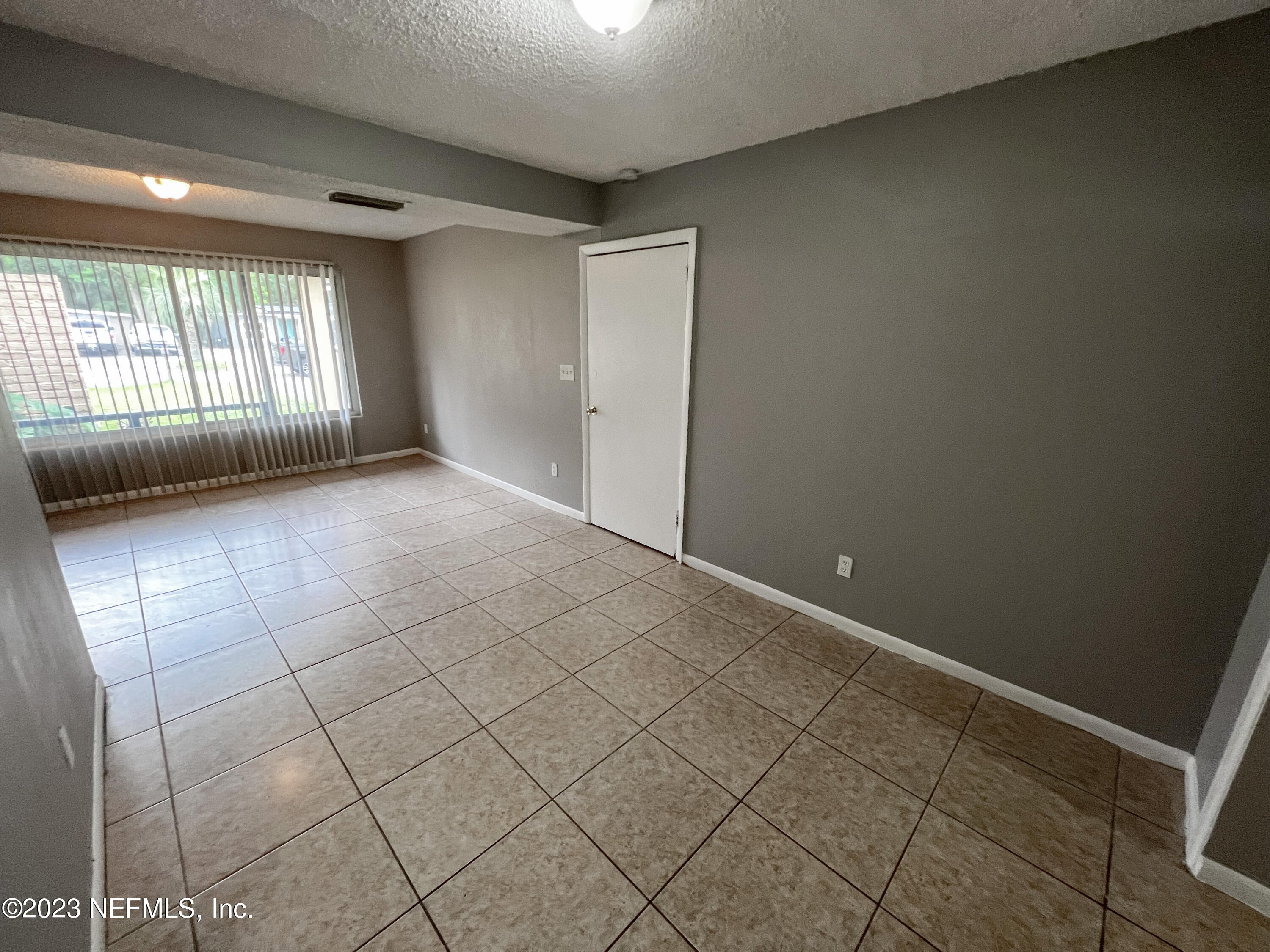 7025 Rollo Road Jacksonville, FL 32205 - Photo 7 of 37 an empty room with windows